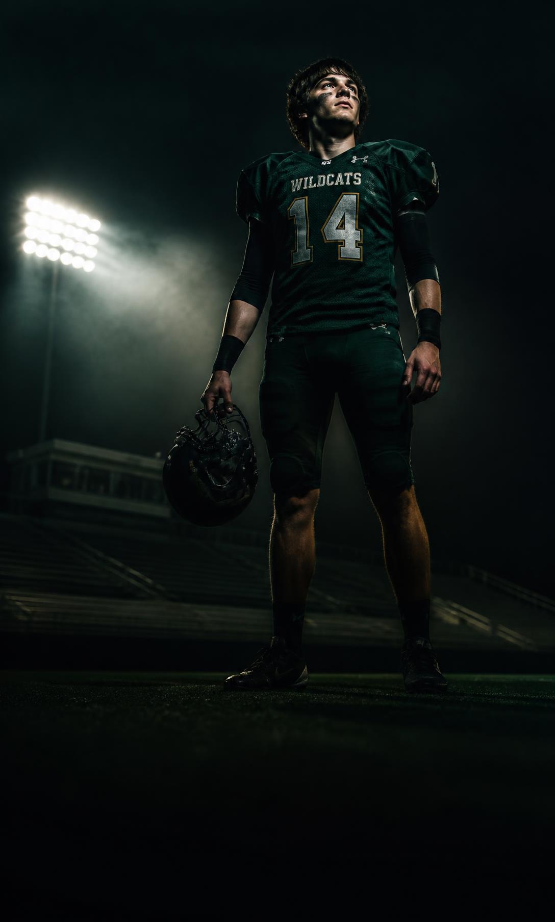 Football player under stadium floodlights at night
